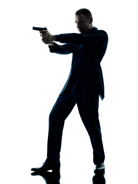man with a handgun silhouette isolated - Foto, imagen