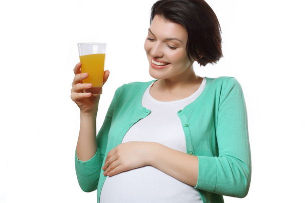 Pregnant woman with juice. Happy mom. Orange juice. - Фото, зображення