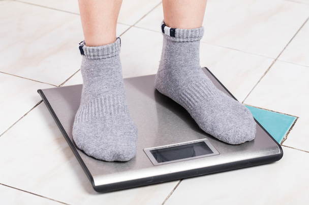 Close up female feet on digital weighting scel. - Photo, Image