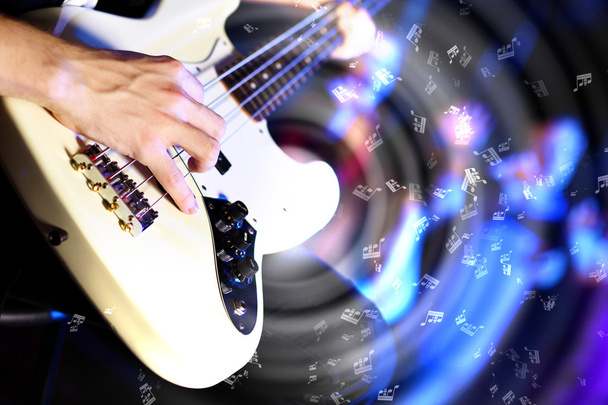 Young guitar player performing in night club - Foto, imagen