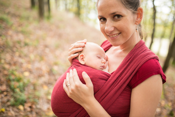 Mother holding her baby daughter, outside in autumn nature - Photo, Image