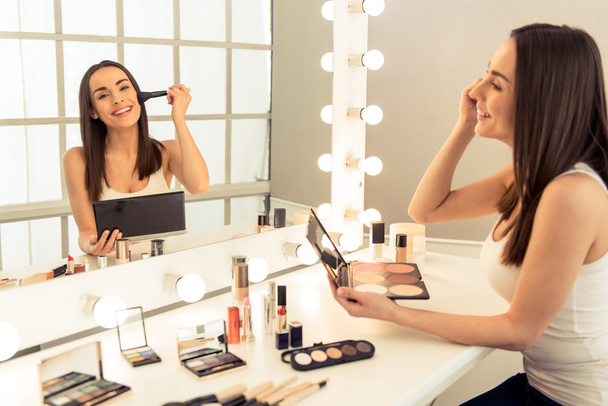 Beautiful girl doing makeup - Foto, afbeelding