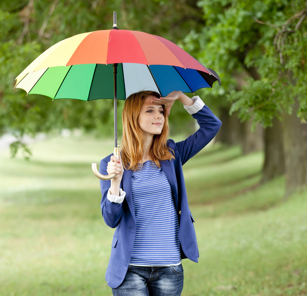 Young fashion girl with umbrella at spring outdoor. - Photo, Image