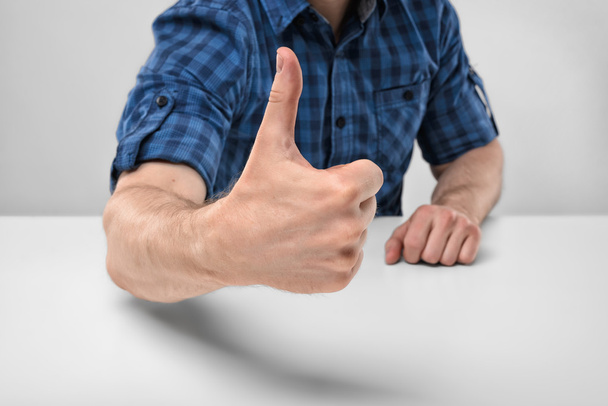 Cropped image of masculine hands showing thumbs up. - Photo, image