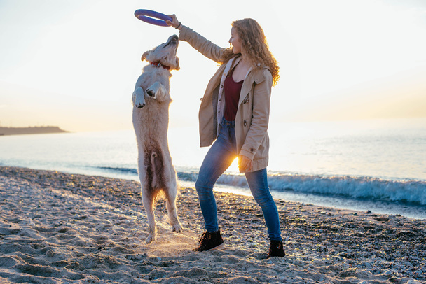 young woman playing with her dog - Foto, imagen