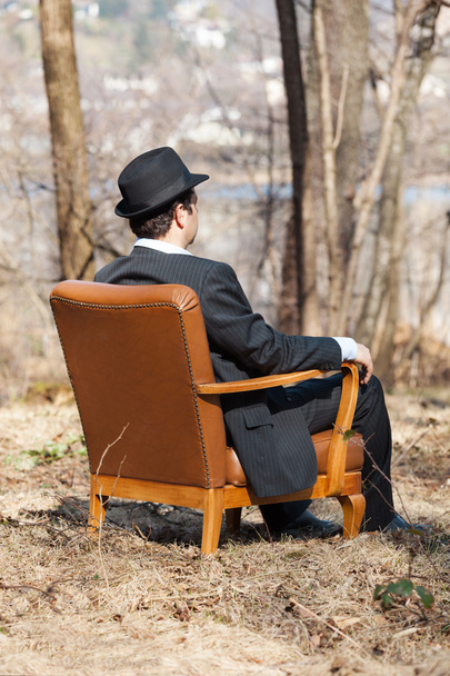 Man sitting alone in a armchair - Foto, imagen