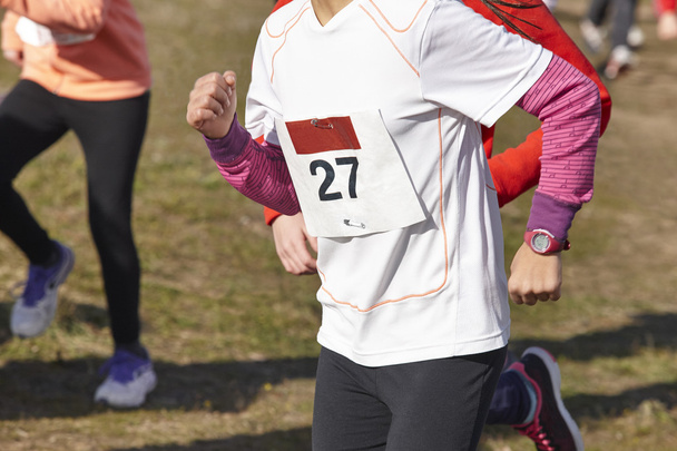 Kobiece lekkoatletycznego biegaczy na wyścig cross country. Zewnątrz obwodu - Zdjęcie, obraz