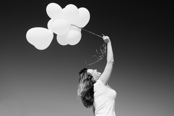 Beautiful woman holding balloons - Foto, imagen