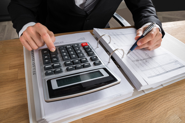 Male Accountant Calculating Tax - Фото, зображення