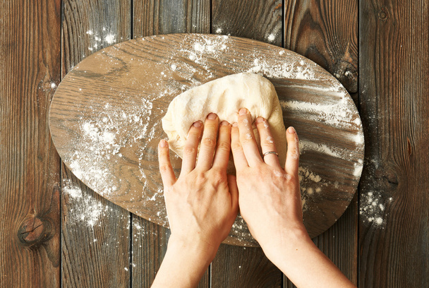 Female hands kneading dough - Foto, imagen