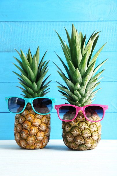 Ripe pineapples with sunglasses  - Fotó, kép