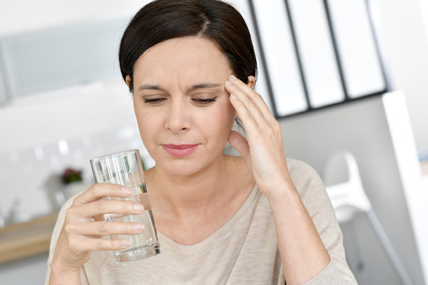 Mature woman having migraine - Фото, изображение