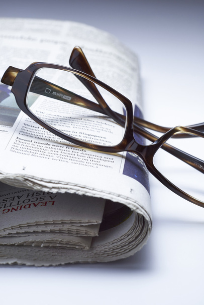 Glasses on newspaper , blue tone - Foto, afbeelding