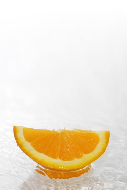 Orangenscheibe auf Wasser - Foto, Bild