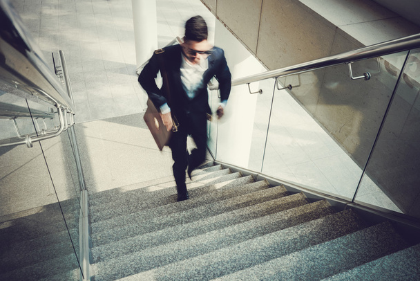 Бизнесмен идет наверх в офисное здание
 - Фото, изображение