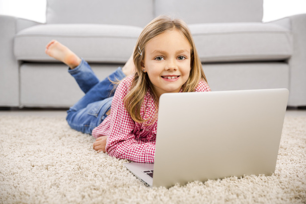 Little girl working with a laptop - Photo, image