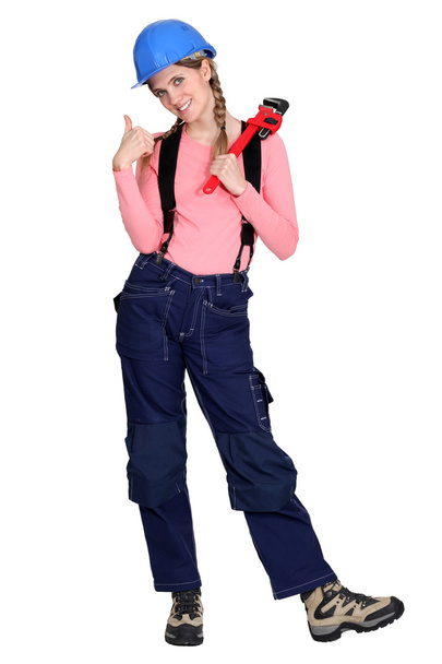 Tradeswoman giving the thumb's up and holding a pipe wrench - Foto, Bild
