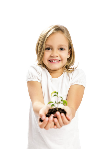 Cute girl showing a plant - Foto, immagini