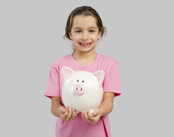 Little girl holding a piggybank - Foto, immagini