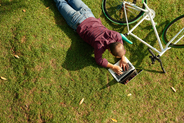 человек с ноутбуком в парке
 - Фото, изображение