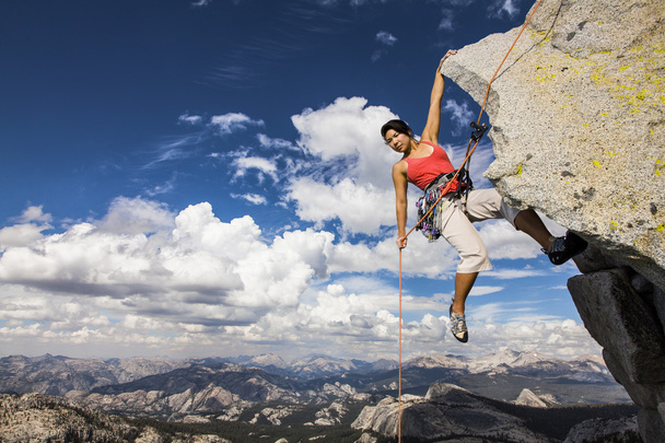 Rock climber clinging to a cliff. - Photo, Image