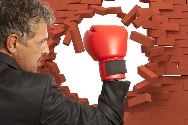 Businessman in boxing gloves and brick wall - Photo, image
