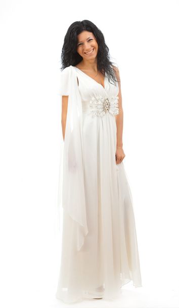 Beautiful girl in white dress standing on white background. - 写真・画像