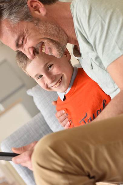 boy playing on digital tablet with daddy - Fotoğraf, Görsel
