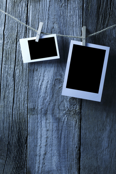 Blank photographs hanging on old wooden wall - Photo, Image