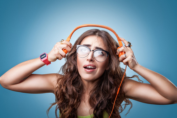 Confused surprised girl  in headphones listening to music. - Photo, Image