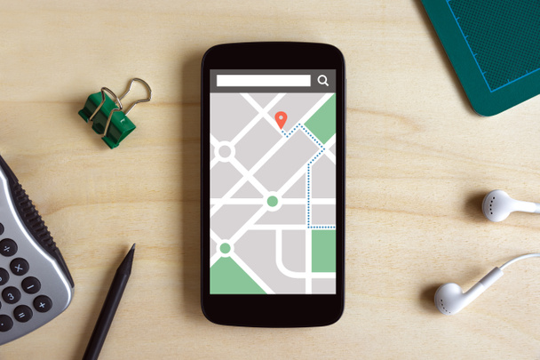 Map gps navigation application on smart phone screen on wooden d - Fotó, kép