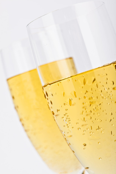 elegant champagne gold glasses isolated on grey - 写真・画像