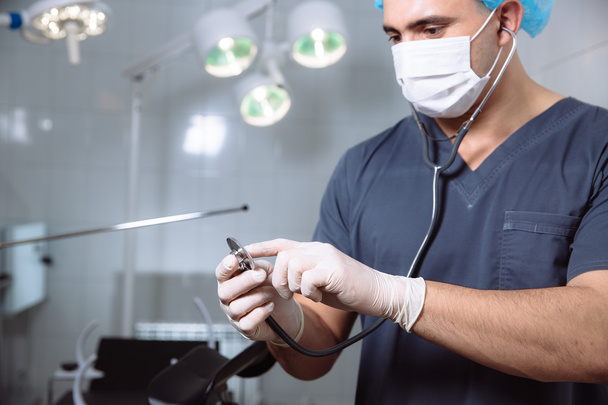 Surgeon man in operating room with medical tools in his hands - Photo, Image