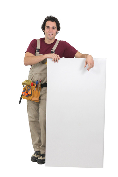 Handyman holding white board - Zdjęcie, obraz