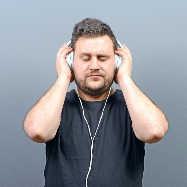 Chubby man enjoying music  - Фото, изображение