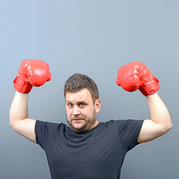 Portrait of chubby boxer posing with boxing gloves as a champion - Foto, immagini