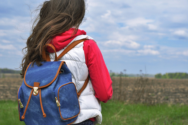 Girl with backpack standing back - 写真・画像