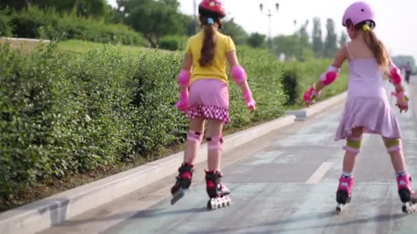  two girls ride on rollers  - Кадры, видео