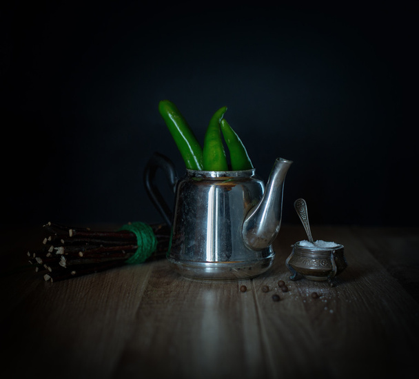 Green chili peppers in a metal teapot - Photo, image