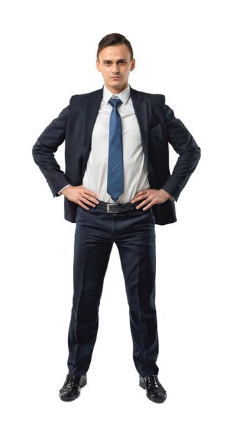 Cutout serious businessman holds his hands on waist. - Fotografie, Obrázek