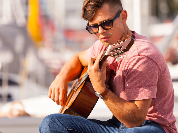 Young man playing guitar. - Φωτογραφία, εικόνα