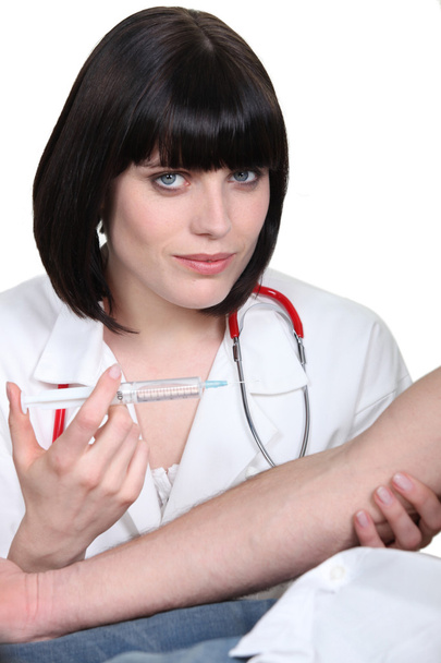 Doctor injecting a patient - Photo, image