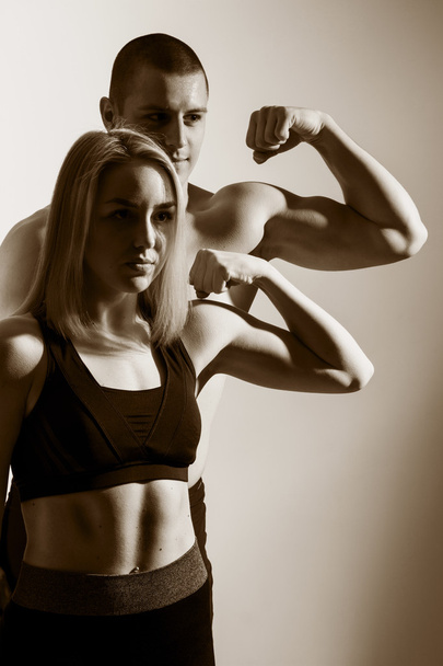 Guy and girl flex biceps. - Photo, Image