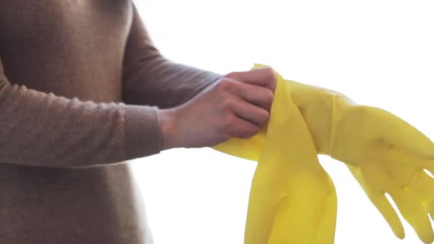 woman putting on rubber gloves for housework - Footage, Video