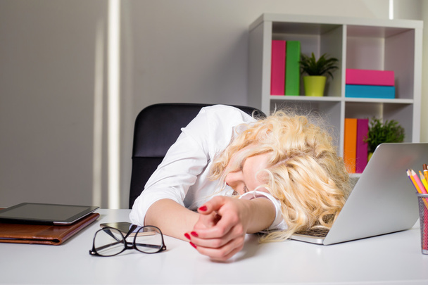 Woman at the office sleaping on the table - 写真・画像