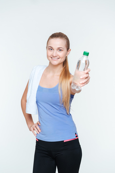Happy sports woman holding bottle with water - Фото, изображение