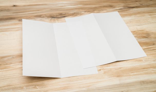 Bifold white template paper on wood texture - Foto, imagen