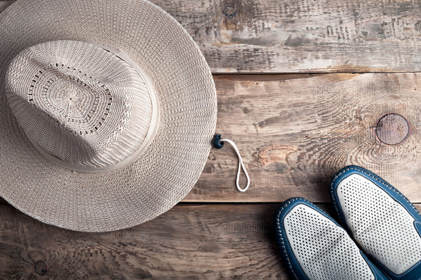 Men's casual accessories hat and shoes on old wooden background. - Photo, Image