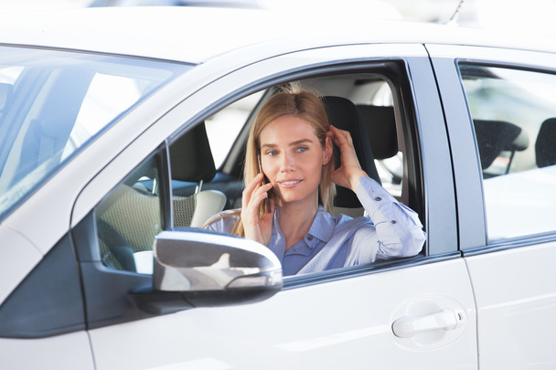 woman talking on phone in car - Photo, image