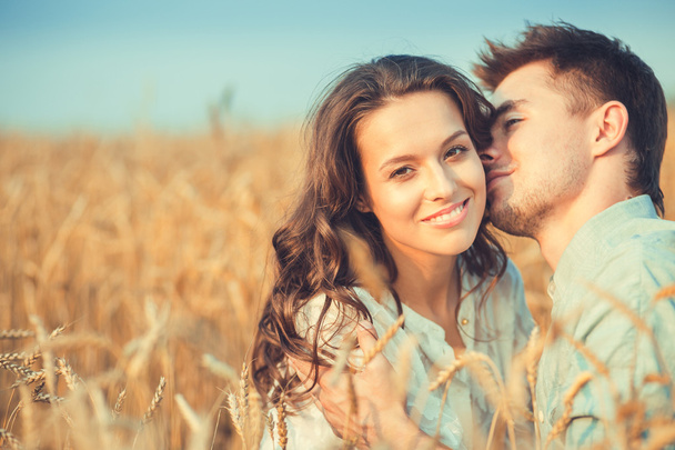 Young couple in love outdoor.Stunning sensual outdoor portrait of young stylish fashion couple posing in summer in field - Photo, Image